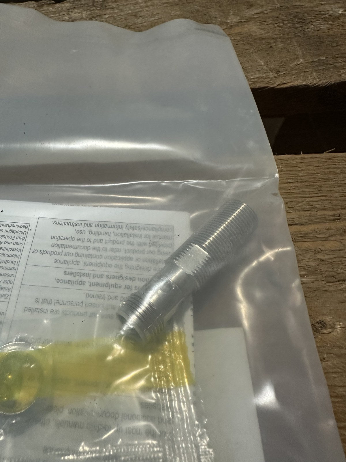 Omron E2E-X4B212-M1 M12 inductive proximity sensor in its bag