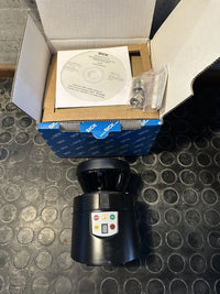 SICK S100 S10B-9011DA laser scanner with its open box, CD and mounting hardware